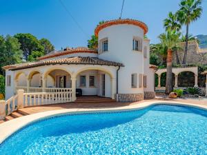 a villa with a swimming pool in front of a house at Villa Villa Rosa by Interhome in Denia