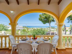 a dining room with a table and chairs on a balcony at Villa Villa Rosa by Interhome in Denia