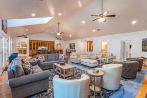 a large living room with couches and tables at Big Oak Manor w/movie theater, hot tub, sleeping for 20! in Oakhurst