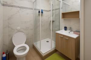 a bathroom with a shower and a toilet and a sink at Exclusive Private Apartment by Warilco - Pleyel 25 m2 - À 1 minute de la station métro Carrefour Pleyel in Saint-Denis