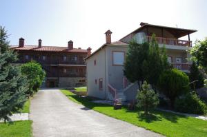 a house with a pathway leading to a building at Villa Platythea in Platy
