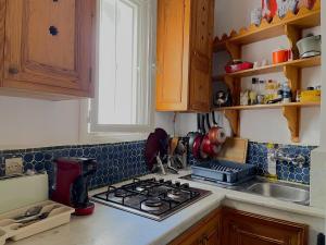 a kitchen counter with a stove and a sink at Gorgeous House in the Heart of the Medina in Tangier