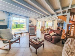 a living room with a couch and chairs and a table at Holiday Home Les Guérins by Interhome in La Trinité-sur-Mer