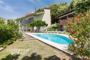 a swimming pool in front of a house at Casa d'Aiguanegra in Sant Joan les Fonts