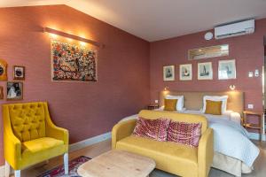 a bedroom with a bed and a couch and a chair at Lady Hamilton Hotel in Stockholm