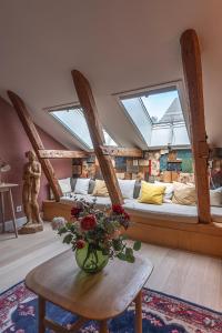 a room with two beds and a vase of flowers on a table at Lady Hamilton Hotel in Stockholm