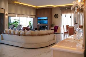 A television and/or entertainment centre at GF Luxury Villa with indoor pool -Afytos