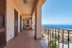 a balcony with a view of the ocean at Moderno Appartamento in Cefalù