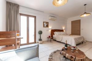 a bedroom with a bed and a table with a bottle of champagne at Kallisti Studios in Naxos Chora