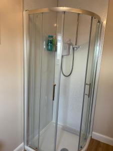 a shower with a glass enclosure in a bathroom at Stepping Stone in Fort William +29 photos