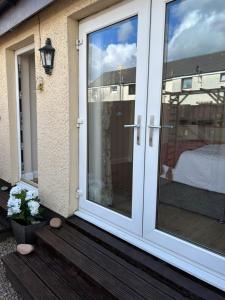 a sliding glass door on a house with a window at Stepping Stone in Fort William