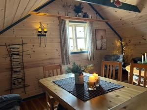 a dining room with a wooden table with candles on it at Støl ved Sognefjorden in Berge