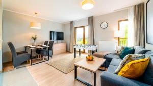 Televízia a/alebo spoločenská miestnosť v ubytovaní Apartamenty Sun & Snow Resort Karkonosze