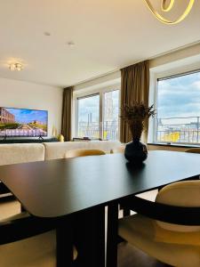 a living room with a table and a couch at Grand Place View - 2bd - Exclusive Apartment in Brussels