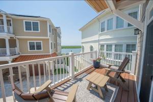 a balcony of a house with two chairs and a table at Paradise on Paradise Way in North Wildwood
