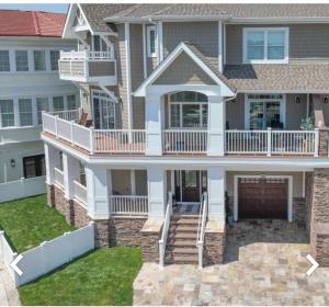 a large house with a porch and a balcony at Paradise on Paradise Way in North Wildwood +11 photos