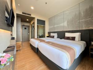 Postel nebo postele na pokoji v ubytování Aveon Hotel Yogyakarta by Daphna Management + 30 fotografií