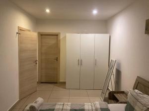 a bedroom with a white cabinet and a closet at The gallery- 1bed room in Madina