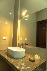 a bathroom with a large mirror and a sink at Casa Hacienda Hotel Boutique in Cajamarca