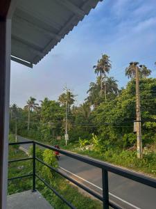 a person walking down a road with palm trees at Sun Bird Villa in Elagawagoda