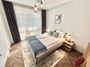 a bedroom with a bed and a large window at "Петър 27" Апартамент До Плажа С Паркинг "Peter 27" Top Center And Private Parking in Burgas City