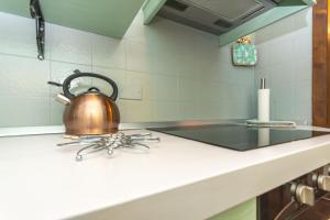 a tea kettle sitting on top of a stove in a kitchen at Chalet Baranci in Pozza di Fassa +27 photos
