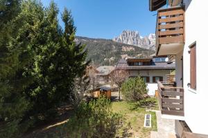 a view from the balcony of a house with mountains in the background at Chalet Baranci in Pozza di Fassa