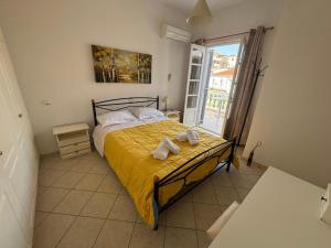 a bedroom with a bed with towels on it at Theo House in Spetses
