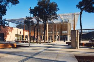 a large building with trees in front of it at Studio Pont du Gard in Sernhac