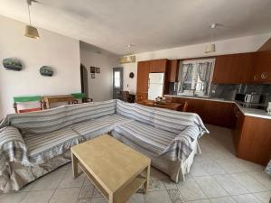 a living room with a couch and a kitchen at Theo House in Spetses