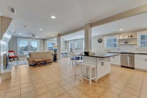 a kitchen and living room with a couch and a table at Boracay by Carolina Beach Realty in Kure Beach