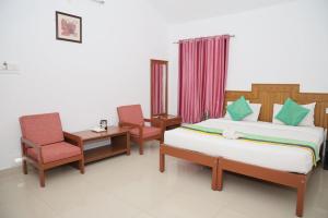 Hotel Yajna Comforts客房内的一张或多张床位