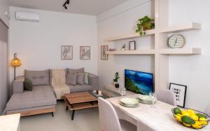 a living room with a couch and a table at Mint Serenity Heraklio near InterClinic in Thérissos