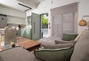 a living room with two couches and a kitchen at Mint Serenity Heraklio near InterClinic in Thérissos