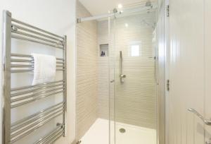 a shower with a glass door in a bathroom at Robin in Polzeath +21 photos