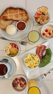 a group of plates of food on a table at Vanguardia Suites in San Juan +16 photos