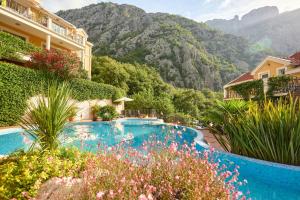 a resort swimming pool with mountains in the background at Apartmani with POOL and VIEW in Gornji Orahovac