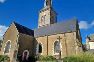 a church with a clock tower on top of it at Jean Vilain in Saint-Jean-sur-Vilaine