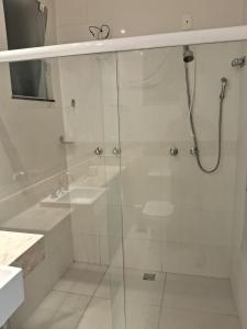 a white bathroom with a shower and a sink at Sollar Imperial in Diamantina +20 photos