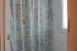 a shower curtain in a room with a window at Casablanca by Carolina Beach Realty in Kure Beach