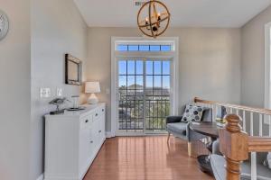 a living room with a table and a chair at Chateau Maizenbleu by Carolina Beach Realty in Kure Beach