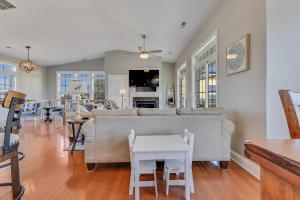 a living room with a couch and a table at Chateau Maizenbleu by Carolina Beach Realty in Kure Beach +29 photos