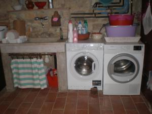 a kitchen with a washing machine and a sink at Agriturismo Podere Torre in Greve in Chianti