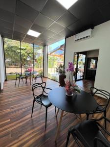 an empty room with tables and chairs and windows at Oriente Hotel in Campo Novo do Parecis +10 photos