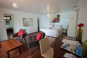 a bedroom with a bed and a living room at Casa da Ilha & SPA in Abraão