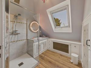 a bathroom with a shower and a sink and a mirror at Maison pour 10 avec grand jardin à 250m de la mer in Louannec +10 photos