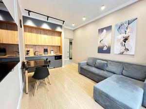 a living room with a couch and a table at Красивая евродвушка на Левом берегу Астаны, район ЭКСПО in Astana