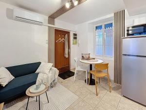 a living room with a couch and a table at Studio Centre Ville Tarbes in Tarbes +18 photos