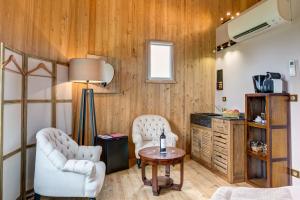 a living room with two chairs and a table at Coup 2 Foudres in Saint-Jean-de-Blaignac