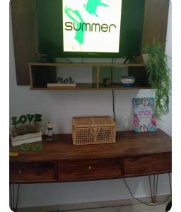 a wooden table with a tv on top of it at Apto na Siqueira Campos, centro in Santarém
